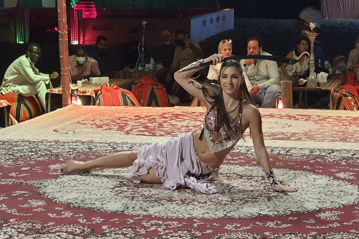 Experience the magic of Dubai's desert with a stunning dinner show where captivating performances bring the night to life perfect for enjoying with friends and family after an adventurous day.